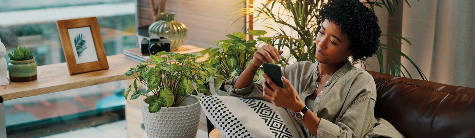 Woman on couch looking at phone.