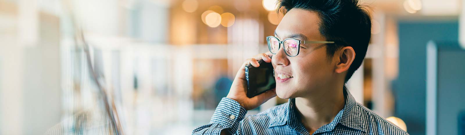 Man talking on phone in office.